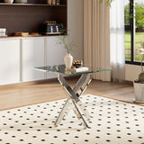 Rectangular glass-top metal table with chrome cross legs, styled in living space