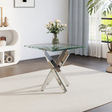 Glass-top metal table with angled chrome legs and clear tabletop, vase on top