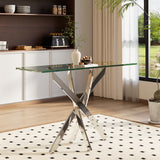 Metal table with clear glass top and angled X-shaped leg frame