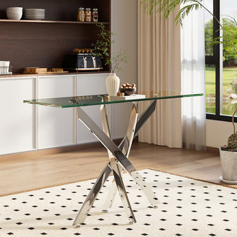 Metal table with clear glass top and angled X-shaped leg frame