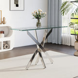 Metal table with clear glass top and X-cross base on four feet