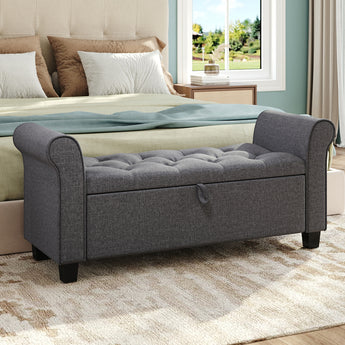 Gray upholstered storage bench ottoman with side armrests and button-tufted cushion