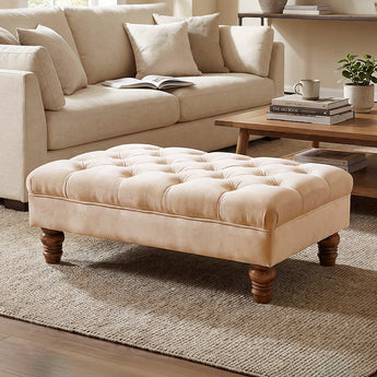 Light beige velvet ottoman footstool with button-tufted top and gourd-shaped legs