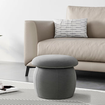 Grey upholstered mushroom footstool with rounded top and cushioned sides