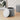 Grey round velvet ottoman storage with padded lid, lift-off top and ridged sides