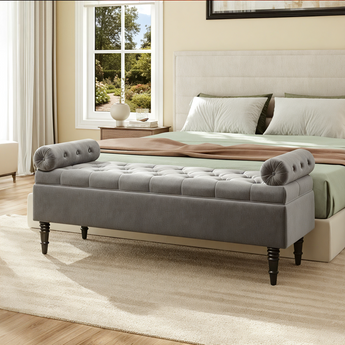 Grey velvet upholstered storage bench with tufted arms and button tufted seat
