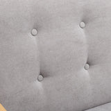 Grey upholstered chair fabric detail with round button-tufting