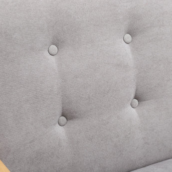 Grey upholstered chair fabric detail with round button-tufting