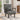 Upholstered single sleeper chair in dark gray fabric with armrest and metal legs