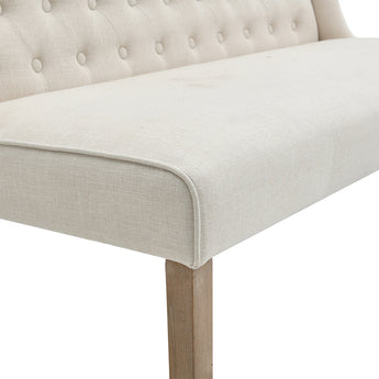 Beige linen bench seat with rounded corner trim and wooden legs