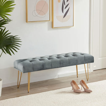 Button-tufted velvet bench, gray cushion with gold hairpin legs—side view