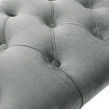 Close-up of button-tufted velvet bench upholstery with gray fabric