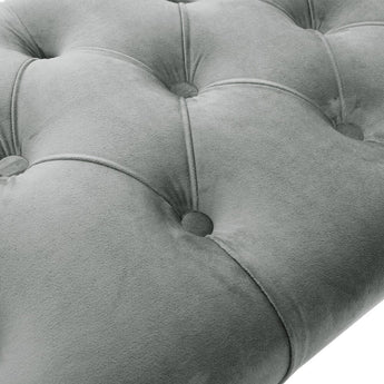 Close-up of button-tufted velvet bench upholstery with gray fabric