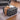 Grey velvet square footstool with deep button tufting and cushioned edges