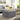 Grey velvet square footstool with button-tufted upholstery and padded top