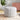 Round teddy fabric footstool, light gray fabric with stitched tufted panels