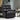 Faux leather recliner armchair in dark gray with padded back and armrests