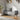 Grey linen upholstered storage bench with tufted base, rounded ends, and wooden legs