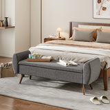 Grey linen upholstered storage bench with hinged lid, wooden legs, and cushioned top