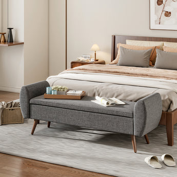 Grey linen upholstered storage bench with hinged lid, wooden legs, and cushioned top