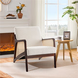 Grey corduroy lounge chair with rattan armrests, dark wood arms and wide cushioned seat