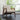 Grey corduroy armchair, rattan armrests and dark wood sides, wide seat and tall back
