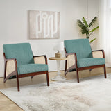Two green corduroy armchairs with rattan armrests and dark wood sides, wide cushioned seats