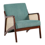 Green corduroy armchair close-up, rattan armrests, dark wood frame and wide seat