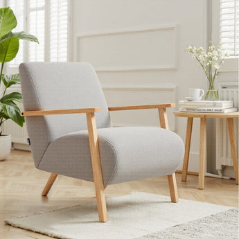 Grey chenille armchair with wide seat, tall backrest, and light wood frame.