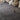 Stone-effect PVC click-lock flooring tiles, dark gray stone-look plank pattern