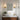 Frameless wall-mounted mirror with rounded corners above vanity