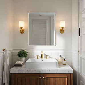 Frameless wall-mounted mirror with rounded corners above vanity
