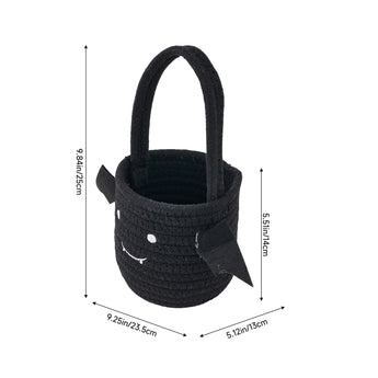 Black woven Halloween treat bucket with handle and spooky face accents