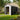 Metal garden storage shed with open front, dark gray panels and white double doors