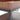 Close-up of wood corner and black steel support leg on a 3-tier trolley