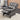 Grey plaid recliner chair with footrest, tufted back cushion, and curved arms.