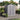Plastic storage shed with double doors and apex roof on wooden deck.