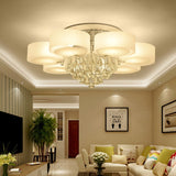 Round ceiling luminaire with frosted acrylic shades and hanging crystal drops, chrome base