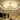 Round ceiling luminaire with frosted acrylic shades and hanging crystal drops, chrome base