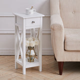 White wooden side table with drawer and open shelf, top with decor