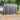 Outdoor plastic storage shed, light grey doors closed with side ventilation vents