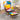 Velvet lounge chair with patchwork back and yellow lumbar pillow, with matching footstool