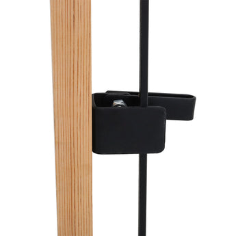 Black wrought iron gate latch bracket on vertical post with visible mounting hardware.