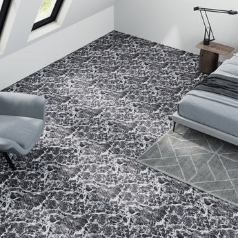 Dark gray marble-look peel-and-stick vinyl floor tiles with white veining