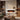 White wall-mounted electric fireplace with orange flame effect and mantel frame
