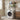 Black 2-tier over-washer storage rack with toiletries on shelves above a washer