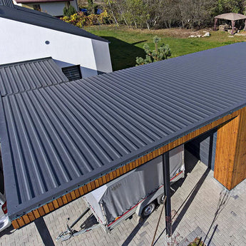 Charcoal black corrugated steel roofing sheet panel on roof eave edge