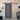 Black sliding barn door hardware kit with overhead rail and top rollers, mounted
