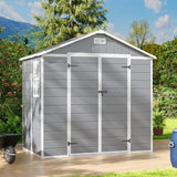 Gray plastic storage shed with double doors closed, apex roof vent and white framing