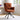 Rust-orange high-back accent chair with tufted back and black swivel legs